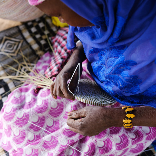 Artisanne weavers creating a basket